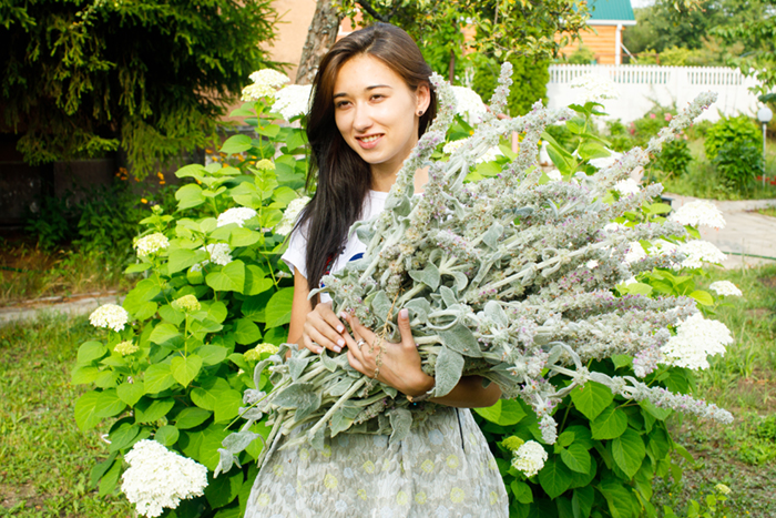 a girl with green herbs